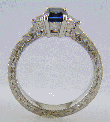 Side view of Cushion-cut sapphire and trilliant diamond hand-engraved platinum ring. (J8415)