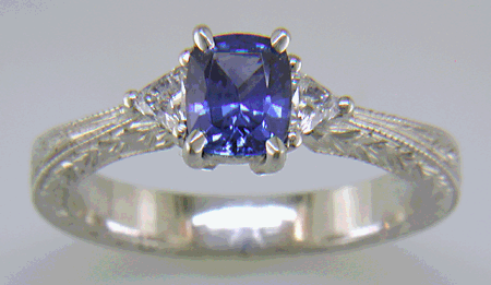 Cushion-cut sapphire and trilliant diamond hand-engraved platinum ring. (J8415)