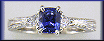Cushion-cut sapphire and trilliant diamond hand-engraved platinum ring. (J8415)