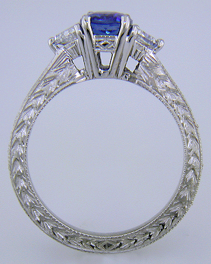 Side view of hand-engraved platinum ring with cushion-cut sapphire and diamonds.