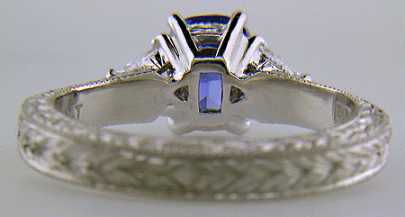 Inside of platinum hand-engraved ring with cushion-cut sapphire and diamonds.