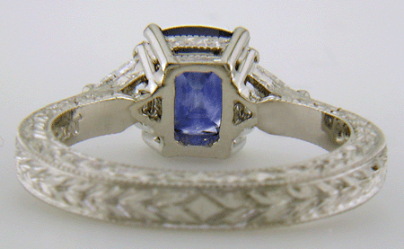 Inside of platinum hand-engraved ring with cushion-cut sapphire and diamonds.
