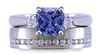 Radiant-cut sapphire set with two round diamonds in a handcrafted platinum ring. (J8522)
