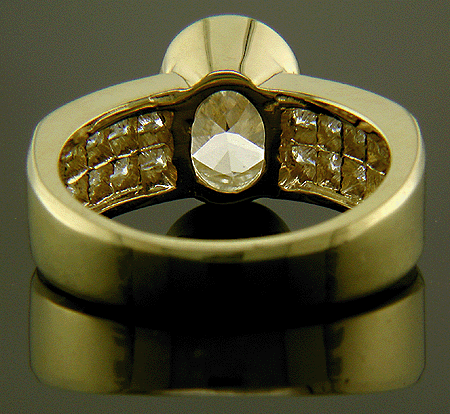 Inside view of oval diamond ring with princess cut side diamonds.