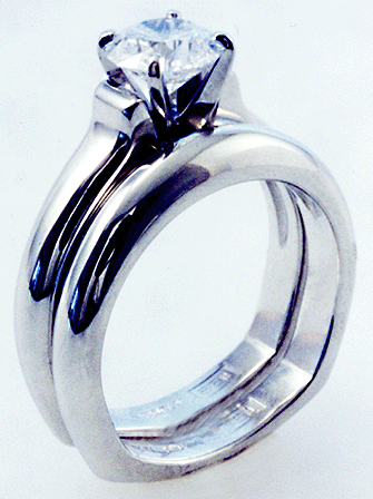 Platinum diamond solitaire ring with matching band.