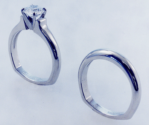 Platinum diamond solitaire ring and matching wedding band.