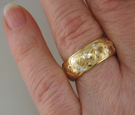 Hand engraved yellow gold band with diamonds