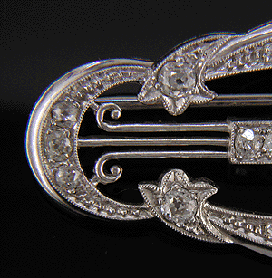 Close up of diamonds, comets and crescent moons in platinum brooch. (J5123)