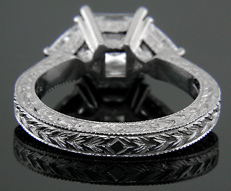 Inside view of engraved platinum ring with princess-cut and trilliant diamonds.