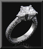 Engraved platinum ring with princess-cut and trilliant diamonds.