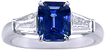 Emerald-cut Sapphire with tapered baguette diamonds in a custom platinum ring. (J8643)