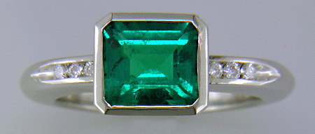 1.6-carat emerald set with round brilliant-cut diamonds in a custom platinum ring.