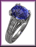 Estate sapphire with diamond ring crafted in engraved platinum.