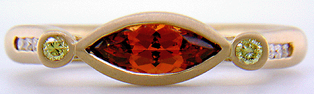 Hand-crafted 18kt gold ring with a Spessartite garnet and diamonds. (J6421)
