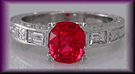 Platinum ring with falmne red spinel and baguette diamonds.