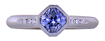 Flanders-cut Sapphire with round diamonds in a custom platinum ring.
