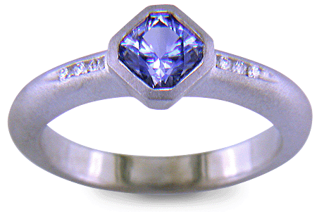 Flanders-cut Sapphire with round diamonds in a custom platinum ring. (J8538)