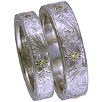 Hand engraved platinum bands set with yellow diamonds.