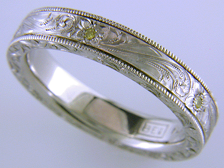 Hand engraved platinum band set with yellow diamonds.