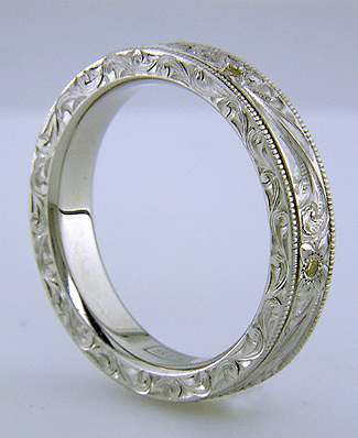 Side view of hand-engraved platinum band set with diamonds.
