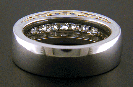 Inside view of custom wedding ring with seven princess-cut diamonds.