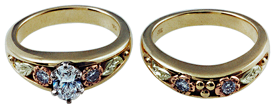 A set of custom wedding rings set with diamonds and crafted from yellow, rose and green gold.