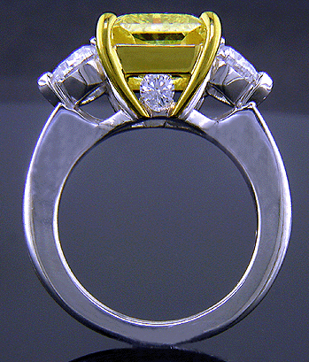 Side view of platinum anniversary ring with a fancy yellow diamond.