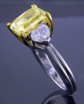 Side view of platinum anniversary ring with a fancy yellow diamond.