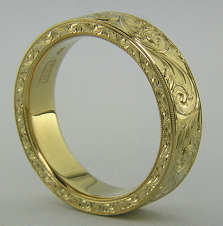 Hand engraved 18kt gold band with flowing scrolls.
