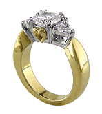 Three-stone diamond engagement rings crafted in 18kt gold and platinum with hidden hearts.