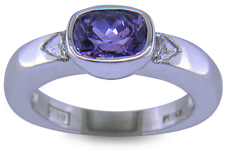 Violet sapphire with trilliant diamonds in a custom platinum ring. (J7238)