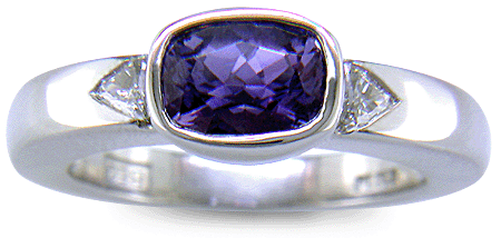 Violet sapphire with trilliant diamonds in custom platinum ring. (J7238)