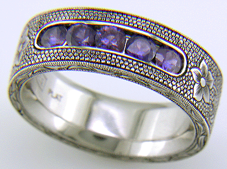 Hand-engraved platinum band with violet sapphires.