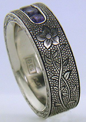 Hand-engraved platinum band with engraved laurel flowers.