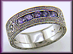 Hand-engraved platinum band with violet sapphires.