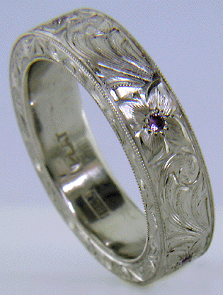 Hand engraved platinum band set with Lavender Sapphires.