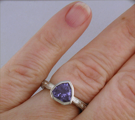 Hand engraved platinum ring with a shield-shape Lavender Spinel. (J8710)