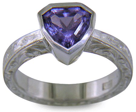 Hand engraved platinum ring with a shield-shape Lavender Spinel. (J8710)