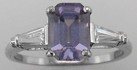 Estate platinum ring with a lavender spinel and two tapered baguette diamonds.