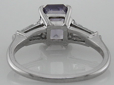 Inside view of platinum ring with a lavender spinel and two tapered baguette diamonds.