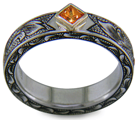 A beautifully hand-engraved ring set with fiery orange Manderin Garnets. (J8703)