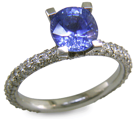 Sapphire set with pave diamonds in a platinum ring. (J8426)