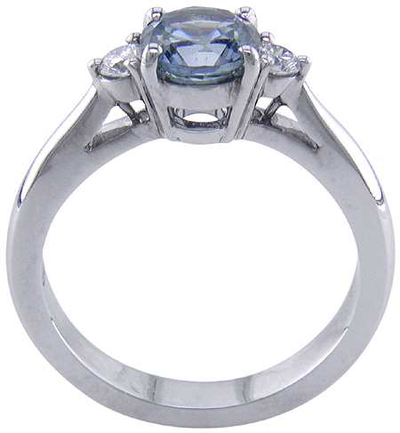 Side view of Montana Sapphire set with two round diamonds in a handcrafted platinum ring. (J8536)
