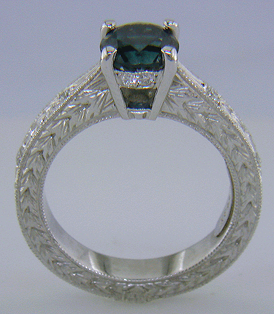 Side view of platinum engraved ring with Montana sapphire and diamonds.