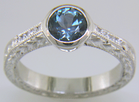 Platinum engraved ring with Montana sapphire and diamonds. (J8544)