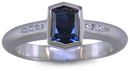 Morph-cut Sapphire with round diamonds in a custom platinum ring. (J8543)
