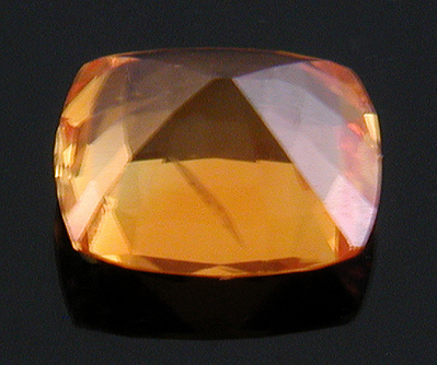 An orange cushion-cut sapphire weighing 3.13 carats. (CS8530)