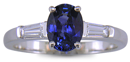 Oval Sapphire set with tapered baguette diamonds in a handcrafted platinum ring. (J8410)