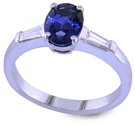Oval Sapphire set with tapered baguette diamonds in a handcrafted platinum ring. (J8410)