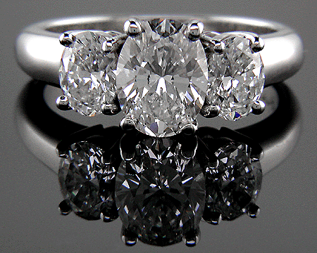 Three stone platinum ring with three oval diamonds.